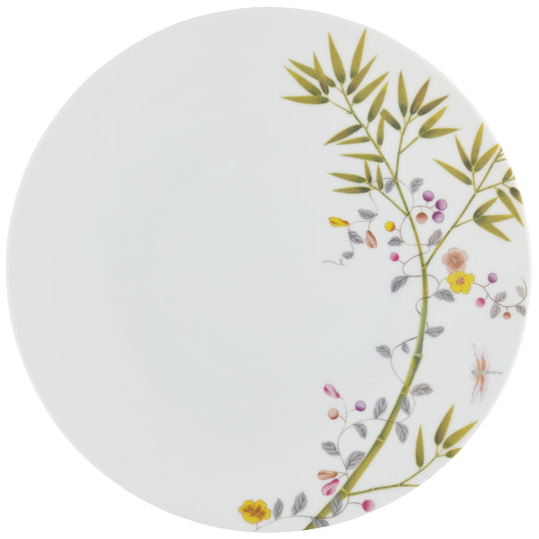 A white porcelain dinner plate with a floral motif featuring birds of paradise and butterflies.