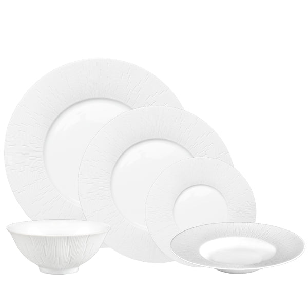 A set of white porcelain dinnerware, including plates and bowls, with a counter-relief engraving pattern.