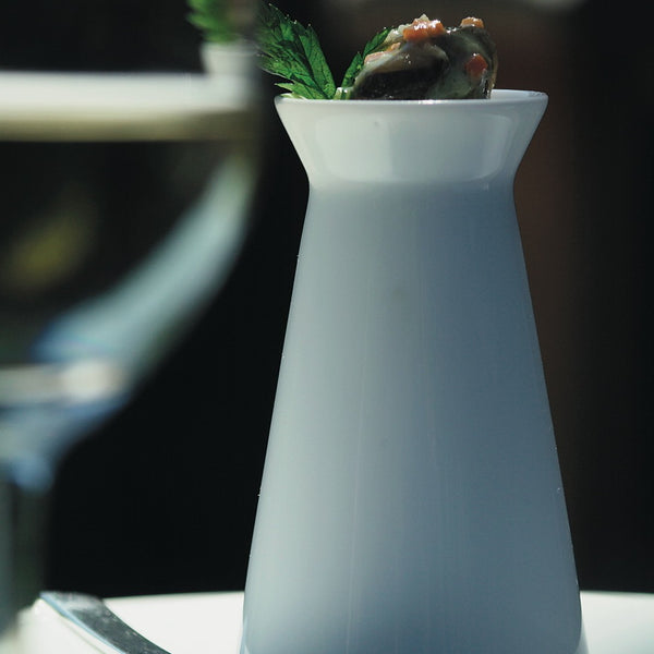 styled Hommage egg cup holder by Raynaud, fine porcelain handcrafted in France with sleek design