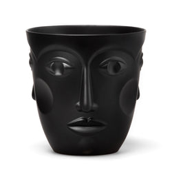 A black porcelain vase with the relief of a female face, displaying eyes, nose, and mouth, with no other visible objects around.
