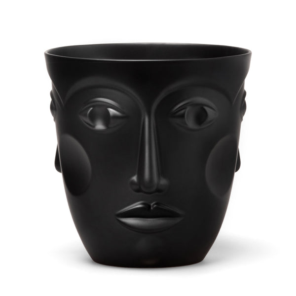 A black porcelain vase with the relief of a female face, displaying eyes, nose, and mouth, with no other visible objects around.