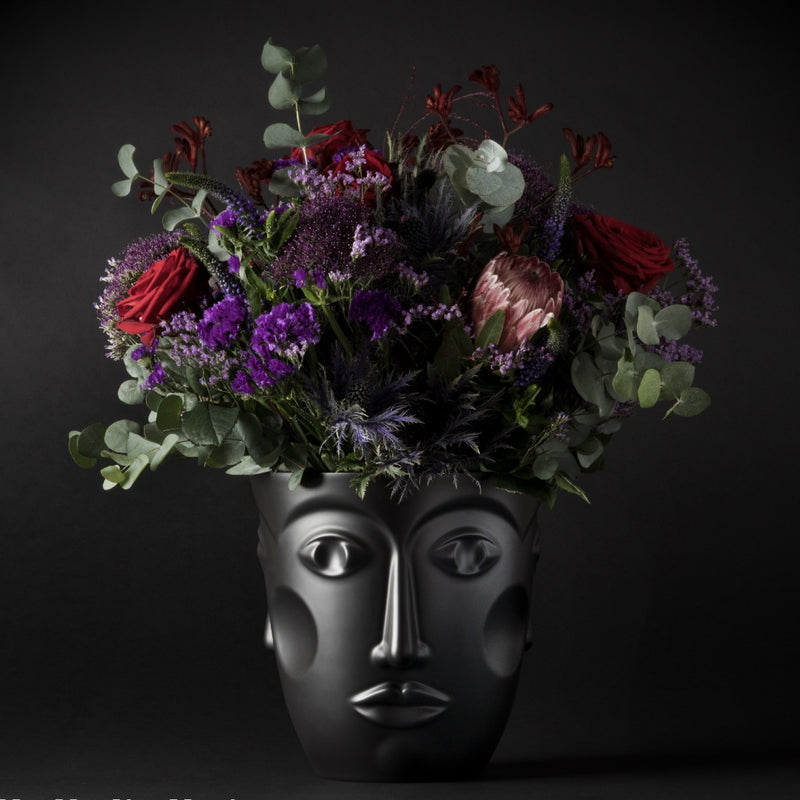Faces porcelain vase and champagne cooler in black satin finish with flowers