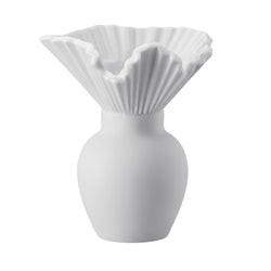 A white matte porcelain vase with a bulbous shape and a pleated collar design.