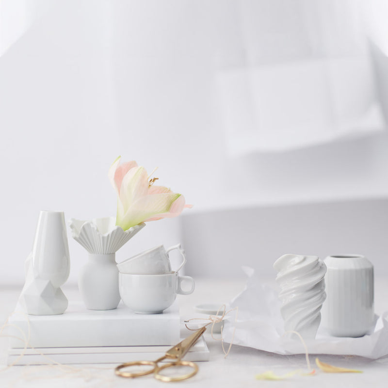mini vases in white by Rosenthal styled with pink flowers white background