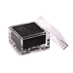 A set of black acrylic coasters with a faux python design, displayed in a clear acrylic box.