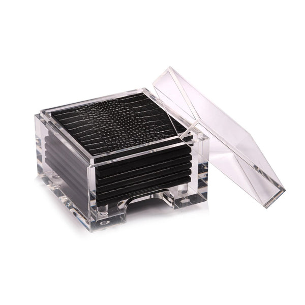 A set of black acrylic coasters with a faux python design, displayed in a clear acrylic box.