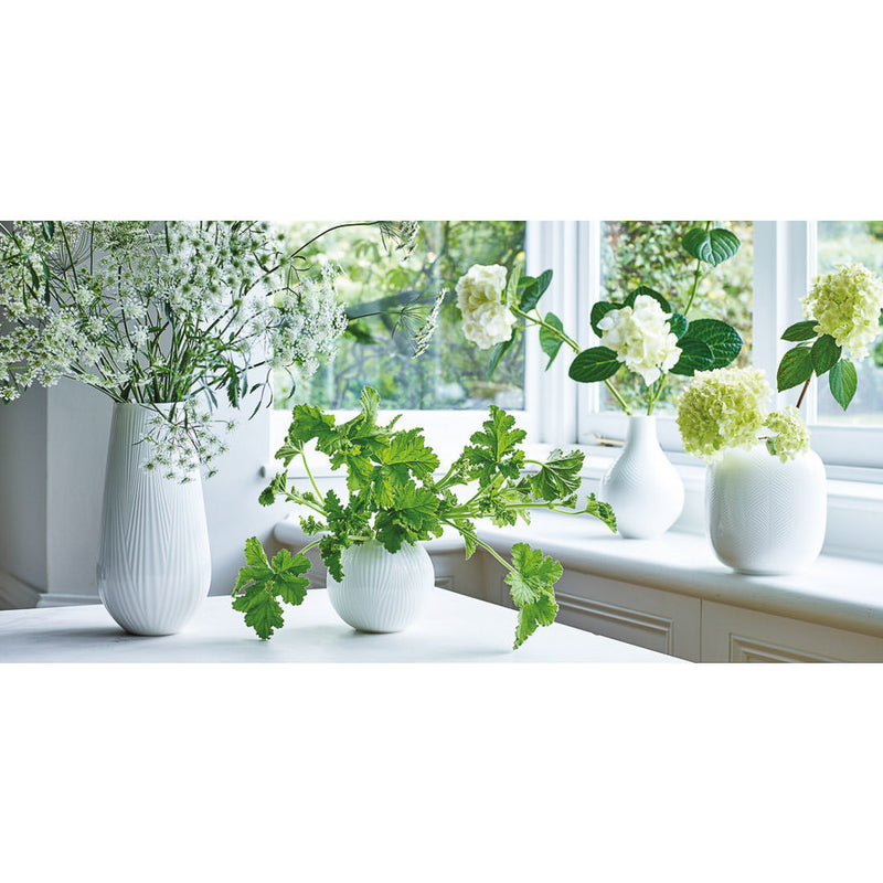 window sill with white vases