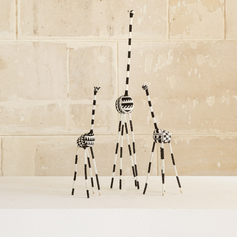 3 decorative giraffes sculpture with a black and white color scheme, featuring traditional wire and glass beadwork.