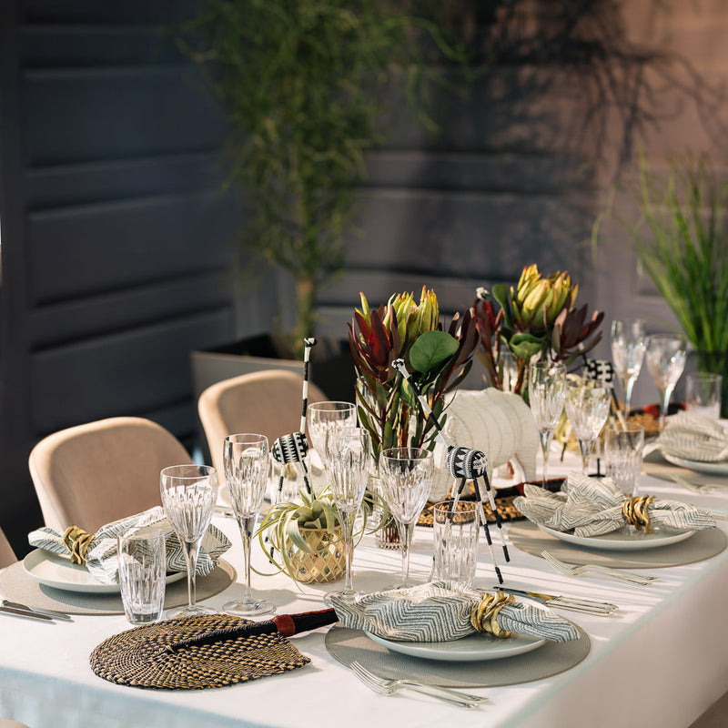 table decor safari theme featuring black and white giraffes and a white rhino figurines