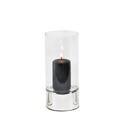A silver and clear glass hurricane lamp candle holder with a lit candle inside, on a white background.
