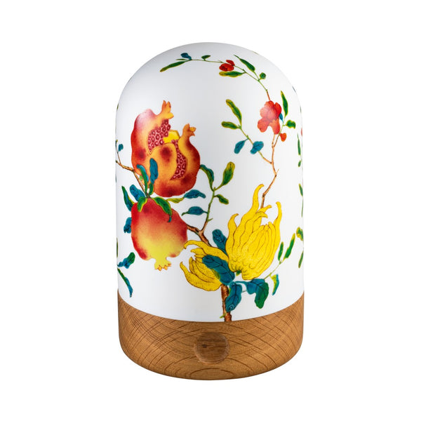 An LED table lamp with a white porcelain shade featuring a colorful floral pattern, and a wooden base.