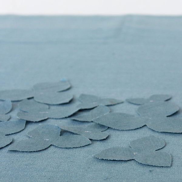 apliquee flowers in blue fabric