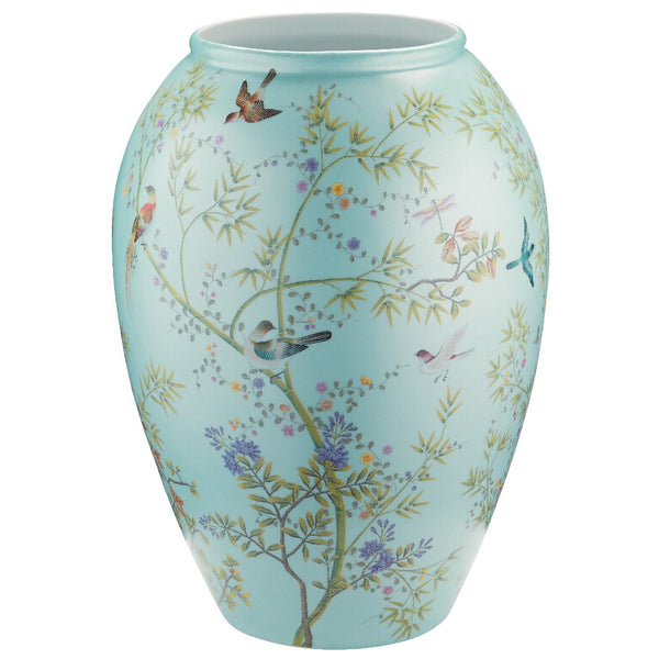 A turquoise-colored porcelain jar featuring a floral and animal pattern, part of the 'Paradis' collection by Raynaud.