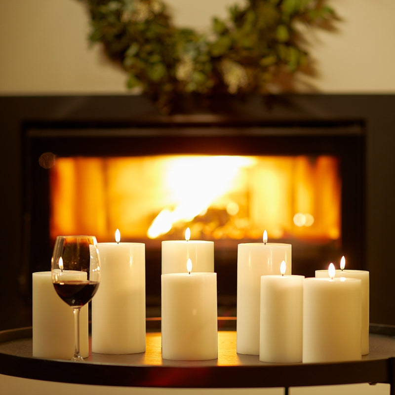 styled fireplace with group of LED pillar candle 20cm in Ivory by Uyuni Lighting with natural melted wax edge
