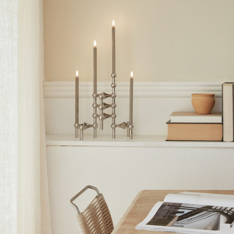 styled counter with LED Stoff Nagel candles in Sand by Uyuni Lighting, sculptural taper design