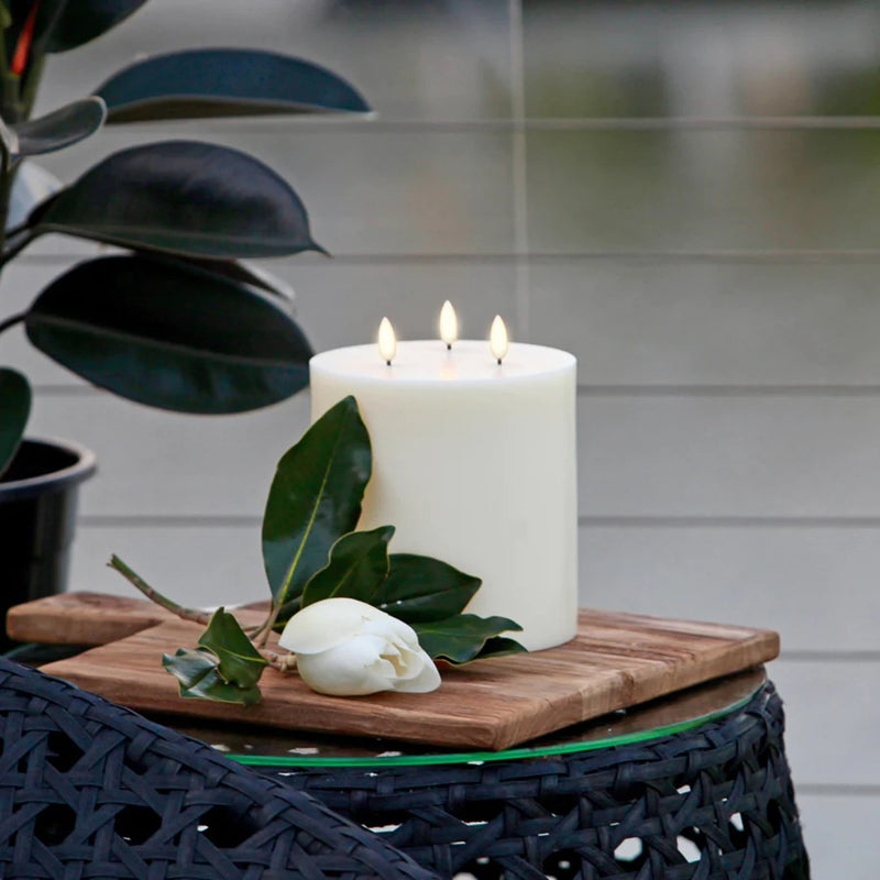 styled outdoor with LED triple flame candle 15cm x 15cm in Nordic White by Uyuni Lighting, wide pillar design