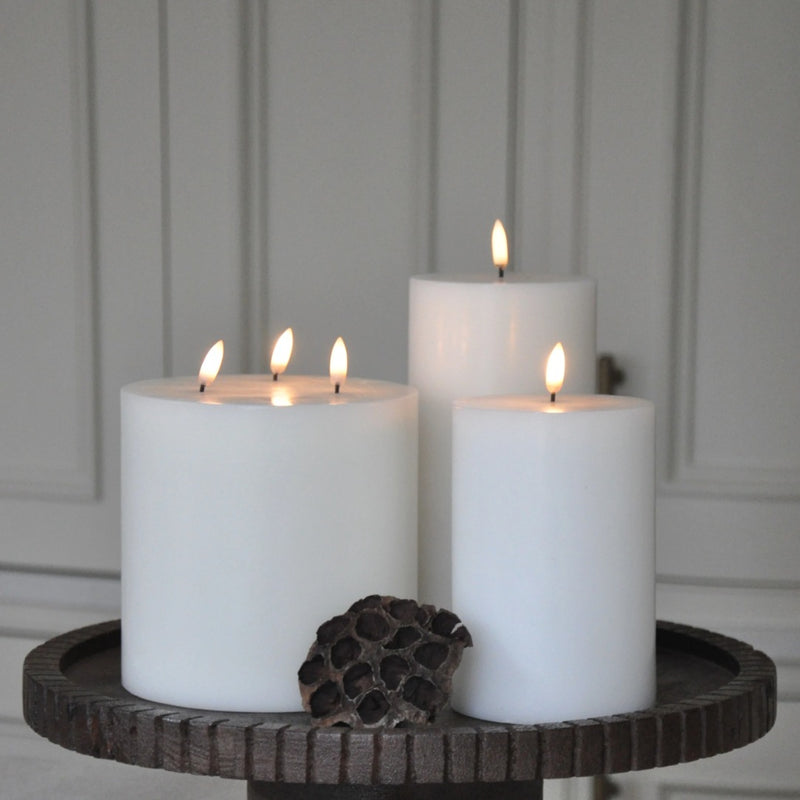 styled side table with LED triple flame candle 15cm x 15cm in Nordic White by Uyuni Lighting, wide pillar design