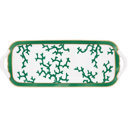 A rectangular white porcelain cake serving plate with an emerald green and gold pattern featuring coral branch shapes along the edges.