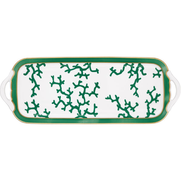 A rectangular white porcelain cake serving plate with an emerald green and gold pattern featuring coral branch shapes along the edges.
