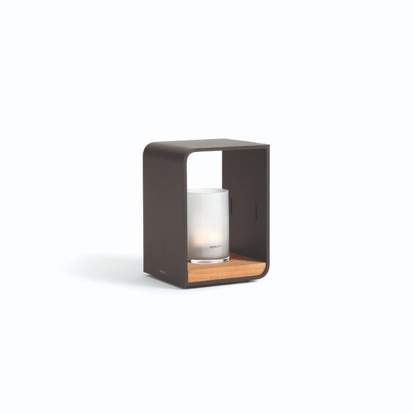 A small rechargeable electric flame lumo outdoor lantern by Manutti, featuring a dark brown frame and a clear glowing tube, set against a white background.