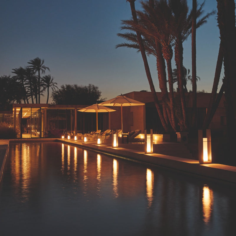 Poolside at evening featuring Lumo lanterns by Manutti