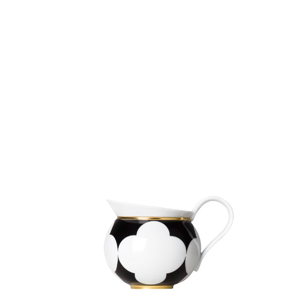 Porcelain milk jug creamer from my china ca d oro collection with black background white quatrefoil motifs and gold rim by sieger furstenberg