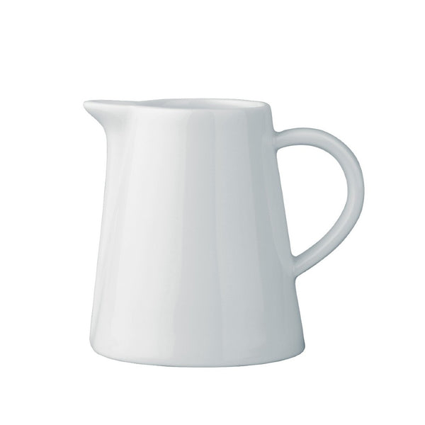 A white, porcelain creamer jug with a wide rim and a handle, against a plain background.