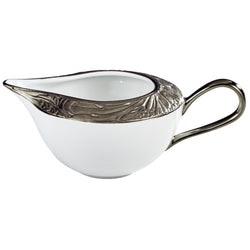 A white porcelain creamer with platinum accents, featuring intricate floral patterns and moiré details.