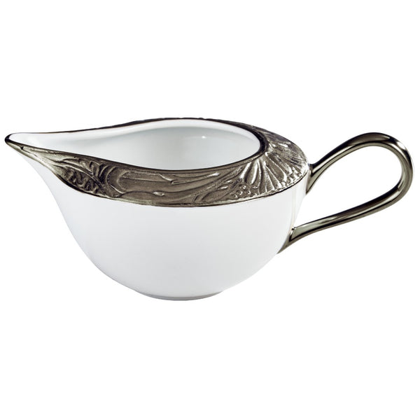 A white porcelain creamer with platinum accents, featuring intricate floral patterns and moiré details.