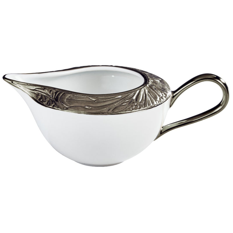A white porcelain creamer with platinum accents, featuring intricate floral patterns and moiré details.
