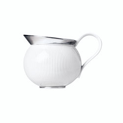 A white porcelain milk jug with platinum detailing and a ribbed texture, with a pouring spout and handle.