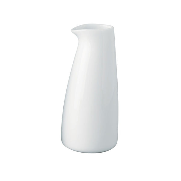 A white porcelain milk pot with a wide rim , against a plain background.