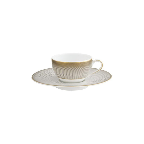 A white porcelain Moka cup with a gold handle and brown geometric pattern on the side, accompanied by a matching saucer.