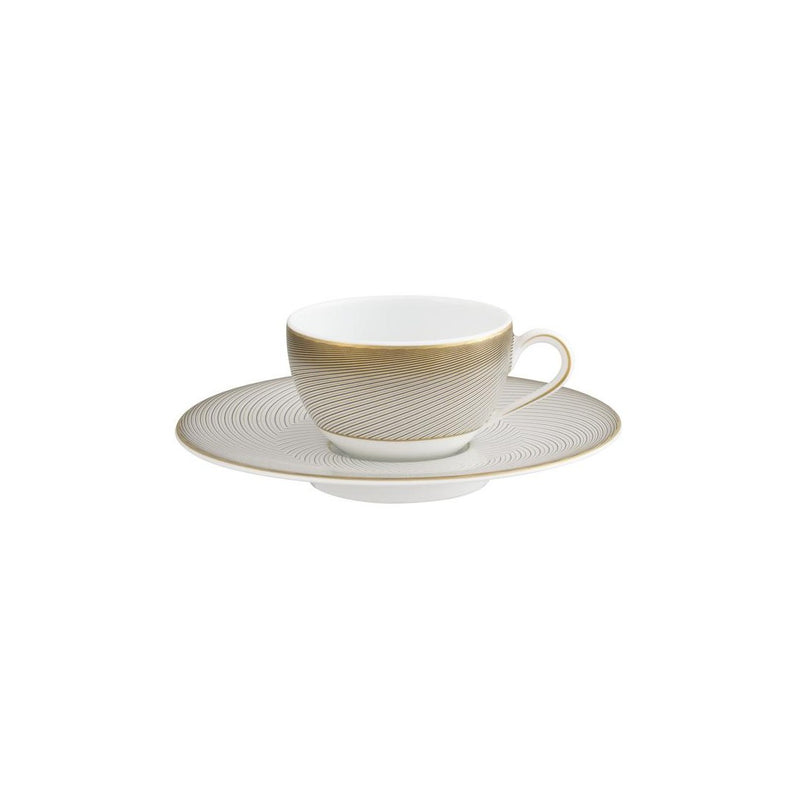 A white porcelain Moka cup with a gold handle and brown geometric pattern on the side, accompanied by a matching saucer.