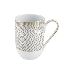 A white porcelain mug with black and gold geometric patterns, featuring a large handle and a tapered design.