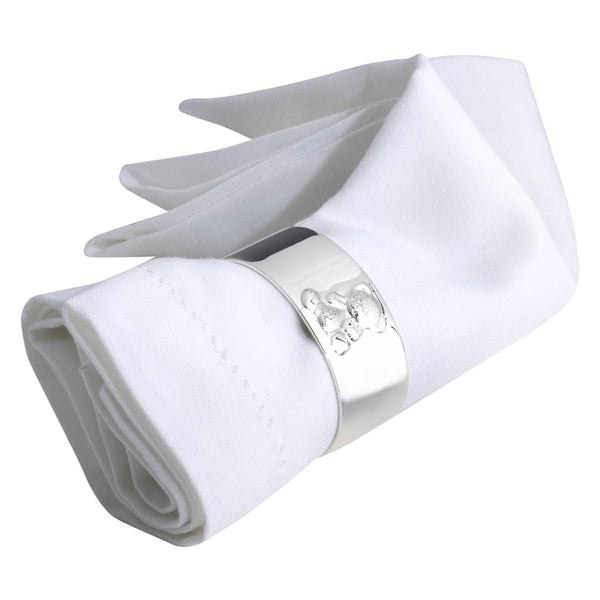 silver-plated napkin ring with engraved teddy bear motif by Sonja Quandt on white linen napkin