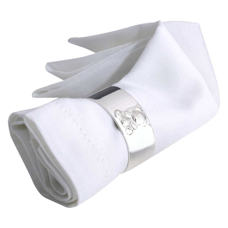 silver-plated napkin ring with engraved teddy bear motif by Sonja Quandt on white linen napkin