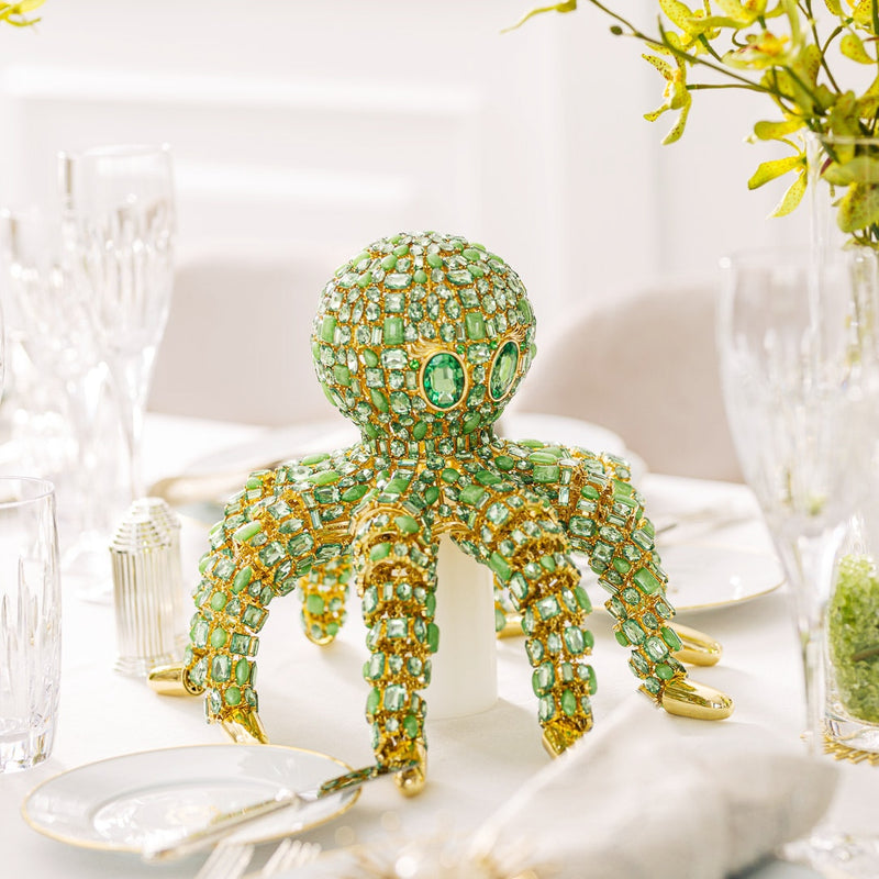 green bejewelled octopus figurine on table