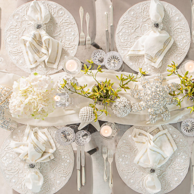table decor with 4 white placemats, flowers and bejewelled octopus