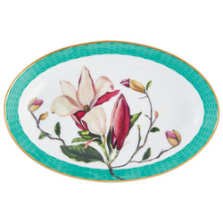 An oval-shaped porcelain serving platter with a floral pattern featuring magnolia flowers, interspersed with honeycomb motifs and gold accents, and a turquoise border.