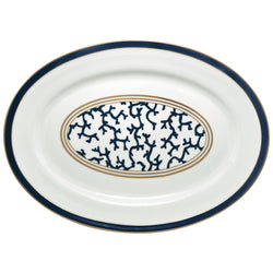 An oval-shaped Raynaud porcelain platter with a marine blue border and an intensive gold central pattern featuring coral branch shapes.