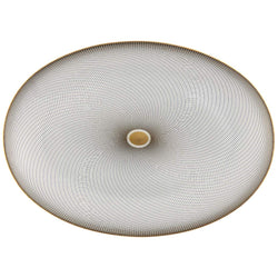 An oval porcelain platter with geometric black and gold patterns on a white background.