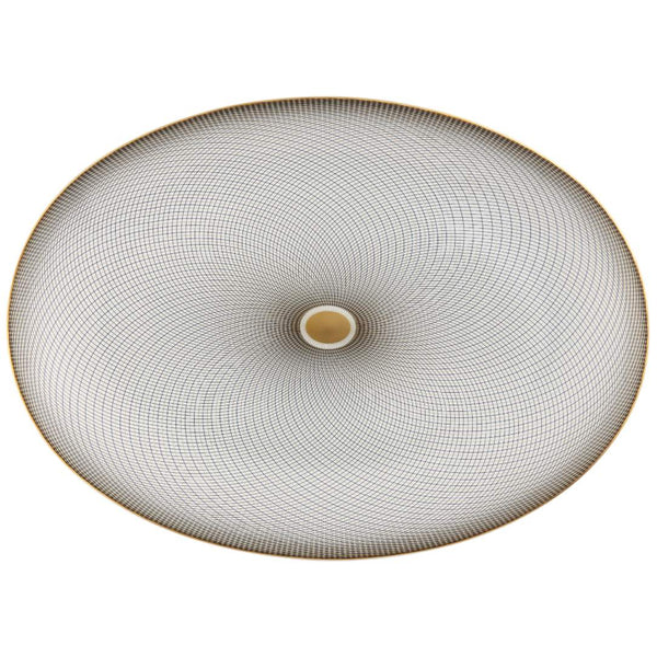 An oval porcelain platter with geometric black and gold patterns on a white background.