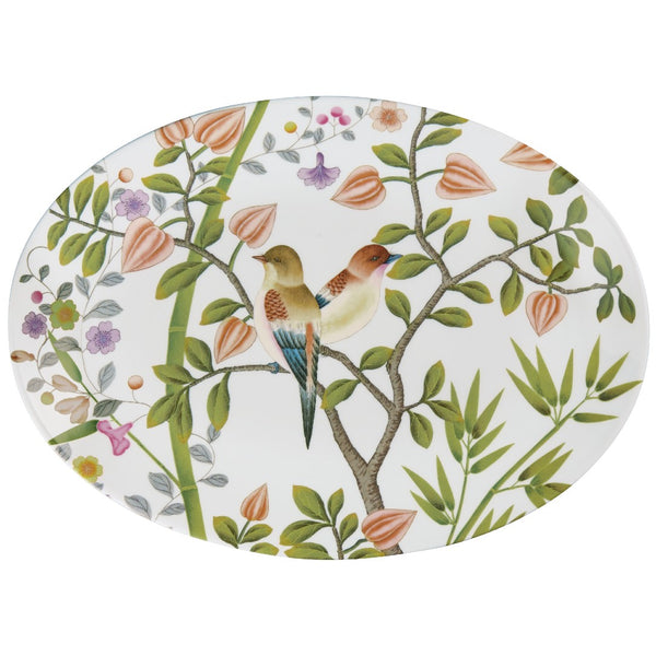 An oval-shaped porcelain platter with a white background featuring colorful floral patterns and birds.