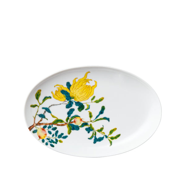 An oval porcelain side dish featuring a naturalistic floral pattern with colors including yellow, blue, and pink.