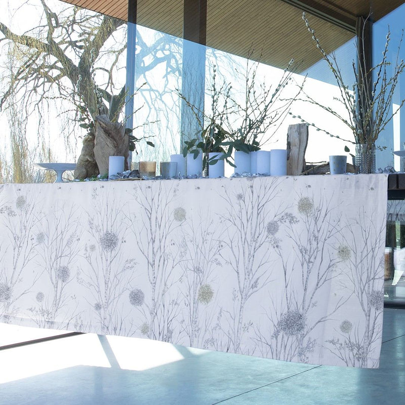 Alexandre Turpault Ovni white linen tablecloth with minimalist geometric border, styled in a modern luxury dining setting