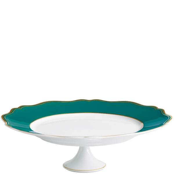 A round, white porcelain cake stand with turquoise and gold accents on the edges, featuring a scalloped and gilded contour.
