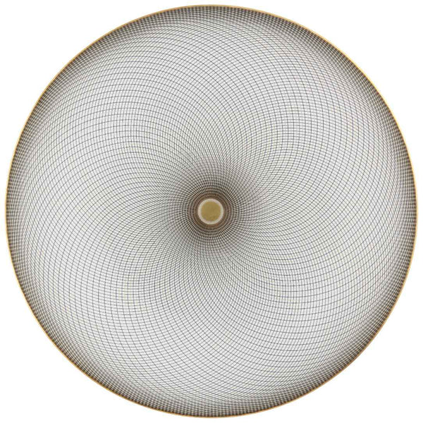 A white porcelain plate with geometric black and gold curves on a round surface.