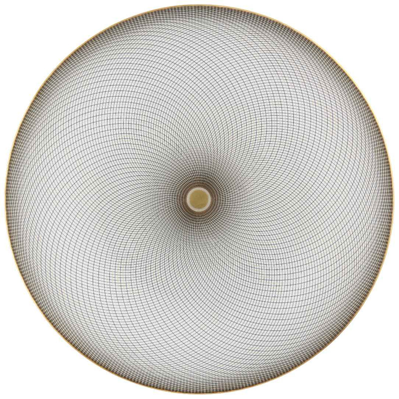 A white porcelain plate with geometric black and gold curves on a round surface.