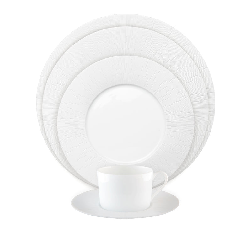 3 different size porcelain plates in white with a coffee cup in front from Haviland collection Infini